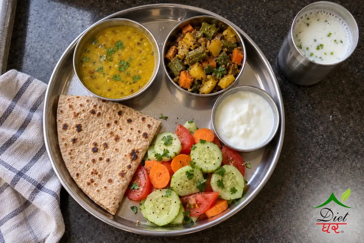 Light Indian thali with one roti, dal, mixed vegetable sabzi, a large salad, curd and a glass of chaas
