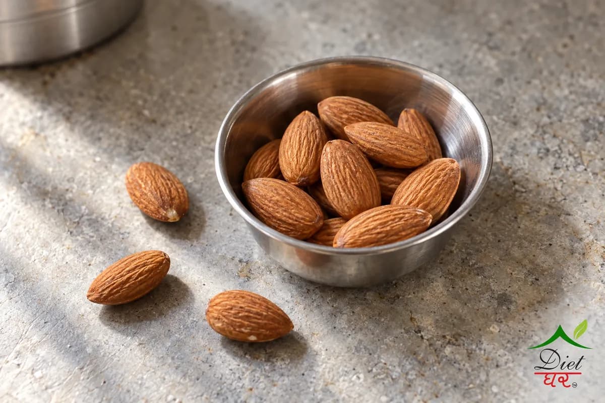 About ten almonds in a small steel katori with a few on the counter
