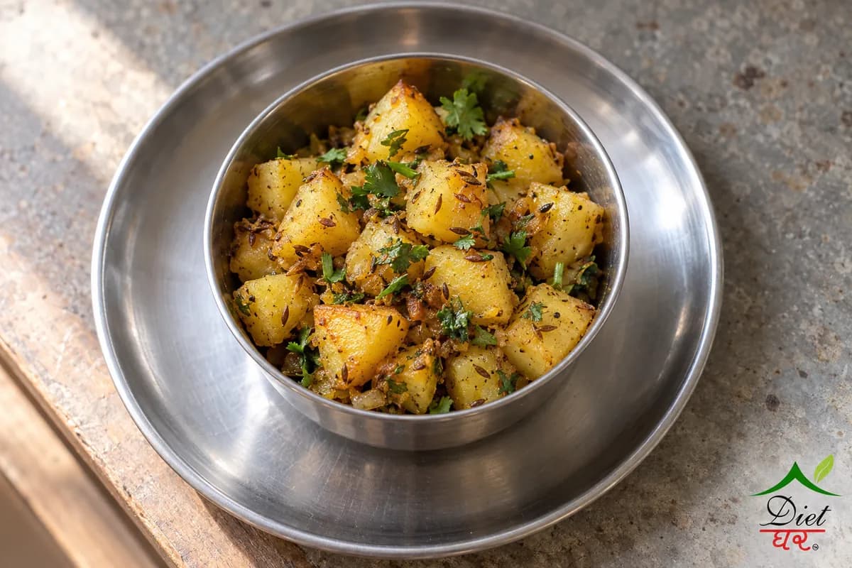 Aloo sabzi, photographed as one steel katori of dry jeera aloo sabzi, in a home kitchen
