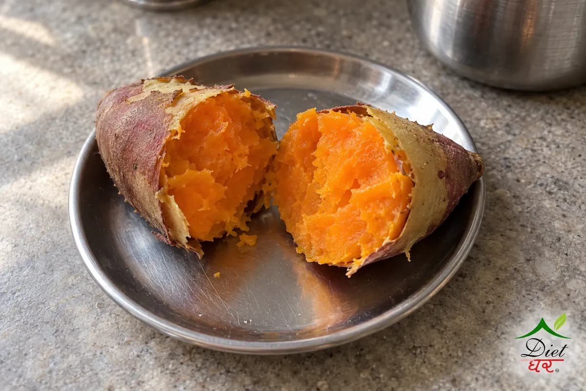 Boiled sweet potato, photographed as one boiled sweet potato cut in half showing orange flesh, in a home kitchen