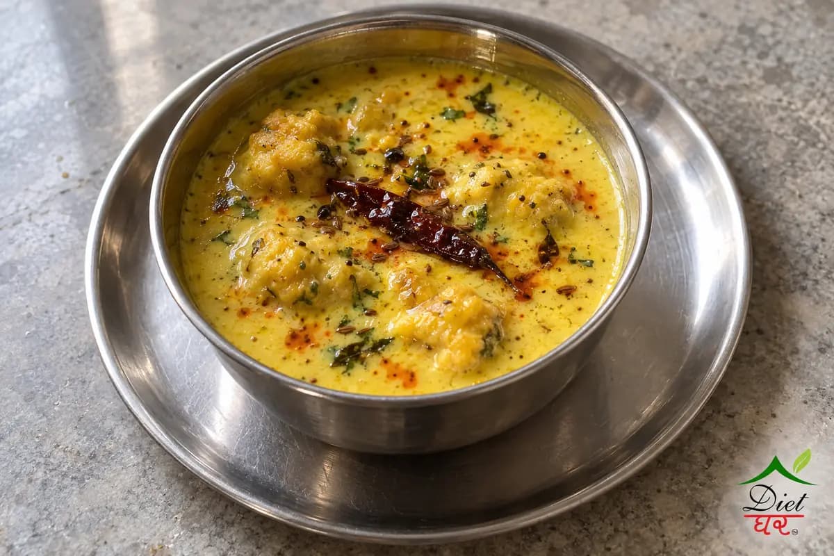 Punjabi kadhi, photographed as one steel katori of yellow punjabi kadhi, in a home kitchen