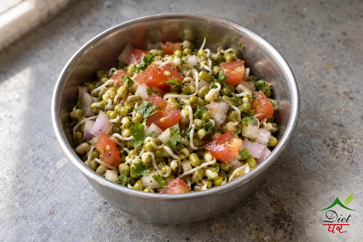 Moong sprouts salad with onion and tomato in a small steel bowl
