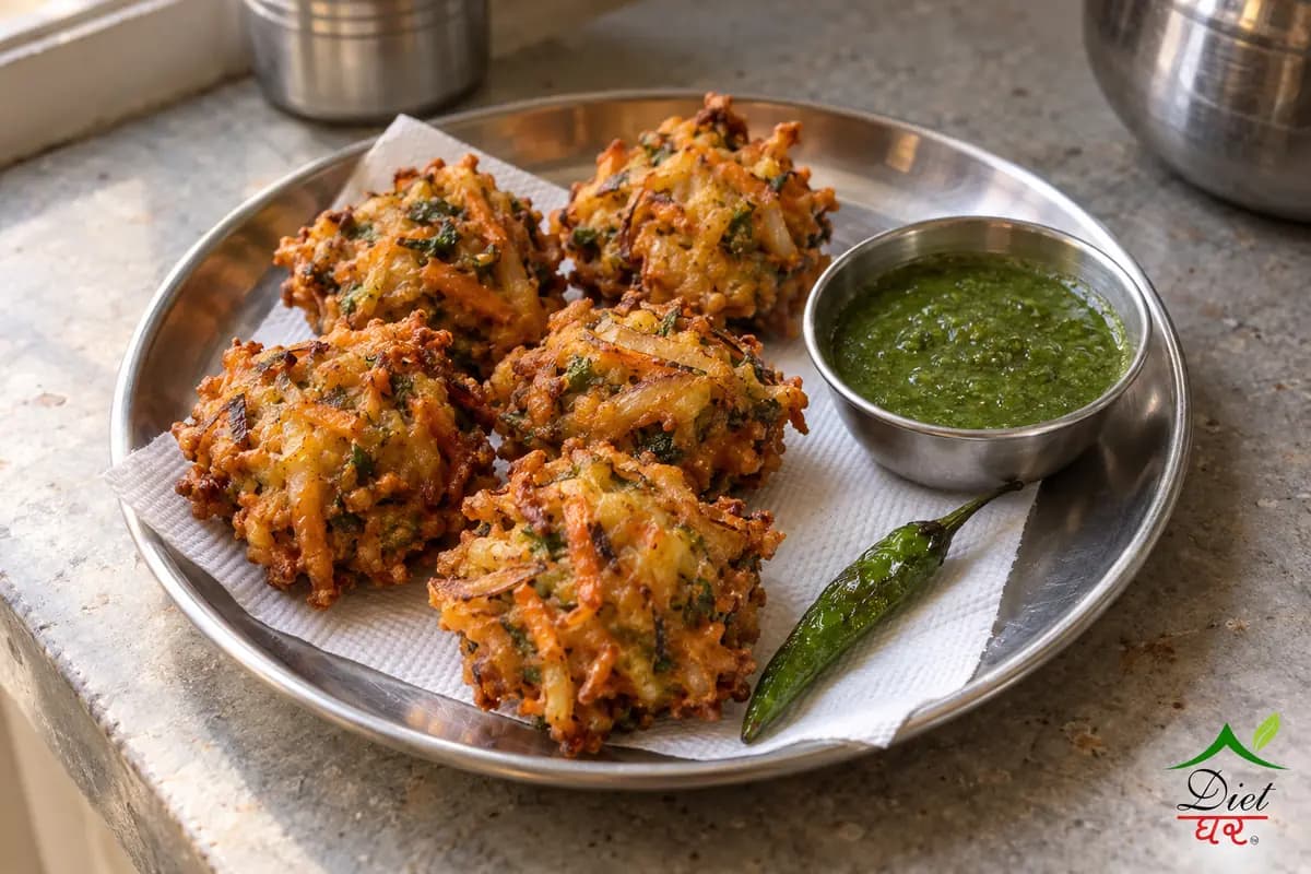 Pakora, photographed as five golden crispy mixed vegetable pakoras, in a home kitchen