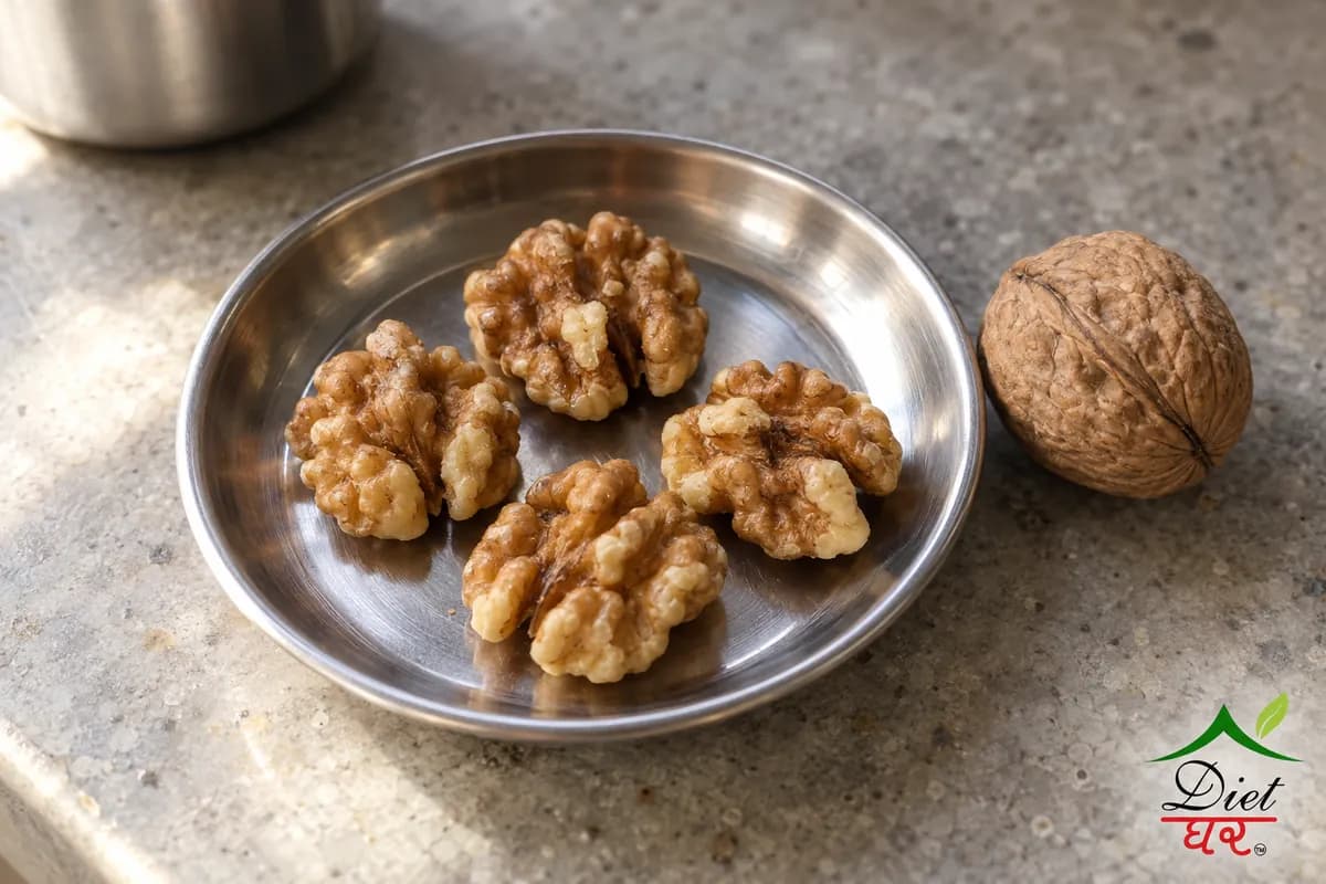 Four walnut halves on a small steel plate beside a whole walnut